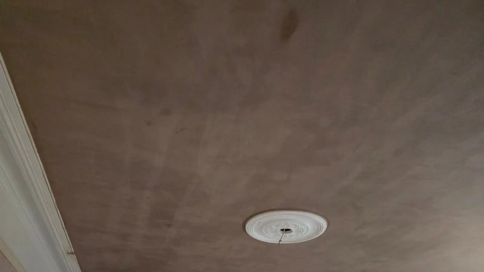 Ceiling freshly skimmed around a ceiling rose by ST Plastering & Rendering