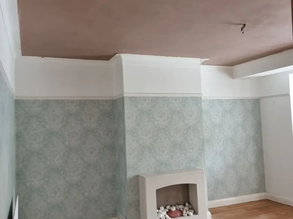 A finished room with a newly plastered ceiling, cleared and the floor swept clean